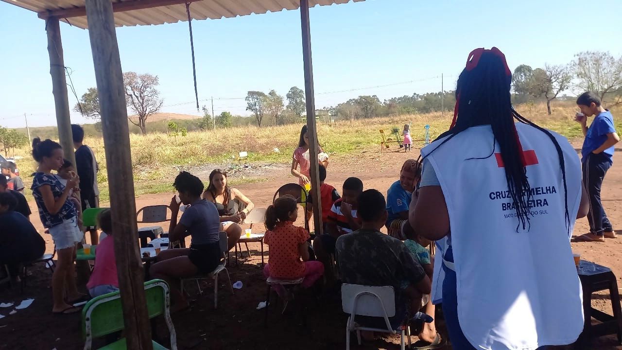 Voluntária da Cruz Vermelha em atividade com moradores da Comunidade Esperança